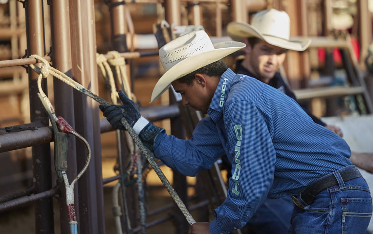 Laramie Mosley warming up the Rossin on his glove and bull rope before riding.
